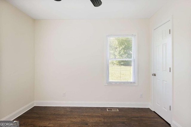 empty room with dark hardwood / wood-style floors