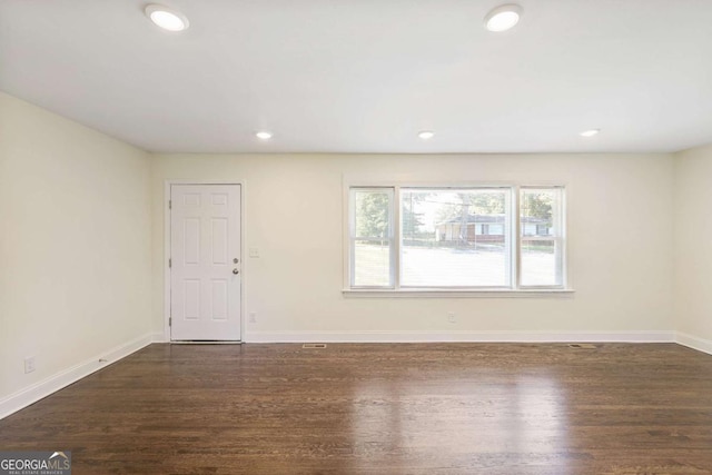 unfurnished room featuring dark hardwood / wood-style flooring