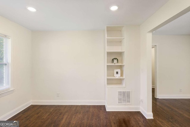 interior space with dark hardwood / wood-style floors and built in shelves