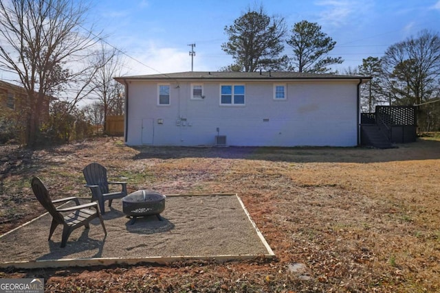 back of property featuring a fire pit