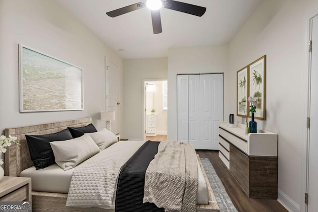 bedroom featuring ensuite bath, dark wood-type flooring, a closet, and ceiling fan