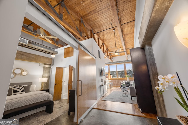 interior space featuring beamed ceiling, a towering ceiling, and wooden ceiling