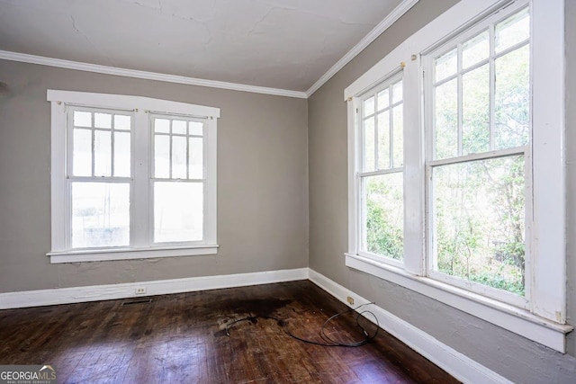 empty room with hardwood / wood-style flooring and ornamental molding