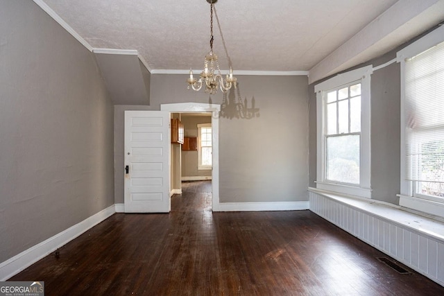 unfurnished dining area with crown molding, a notable chandelier, dark hardwood / wood-style flooring, and a wealth of natural light