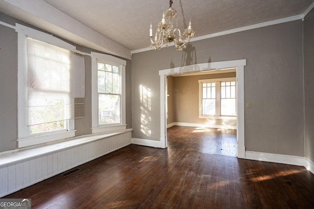 unfurnished dining area featuring an inviting chandelier, ornamental molding, and dark hardwood / wood-style floors