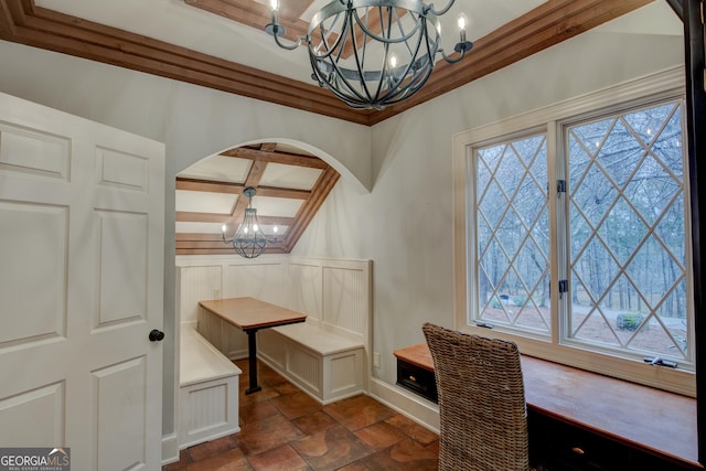 dining space with an inviting chandelier, beam ceiling, coffered ceiling, and a healthy amount of sunlight