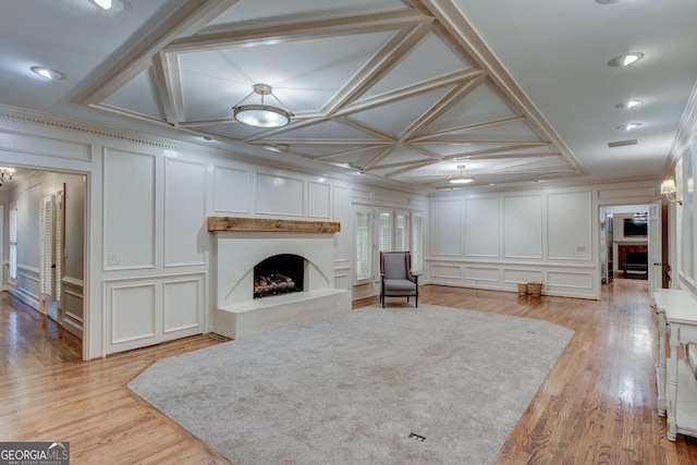 sitting room with crown molding, light hardwood / wood-style floors, and a premium fireplace