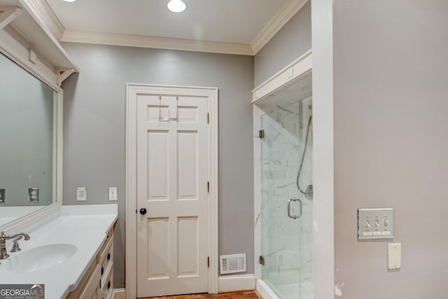 bathroom featuring vanity, an enclosed shower, and crown molding