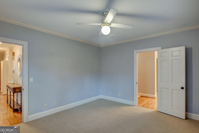 unfurnished bedroom featuring crown molding, ceiling fan, and light carpet