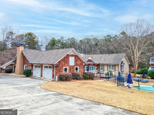 ranch-style home featuring a garage and a front yard