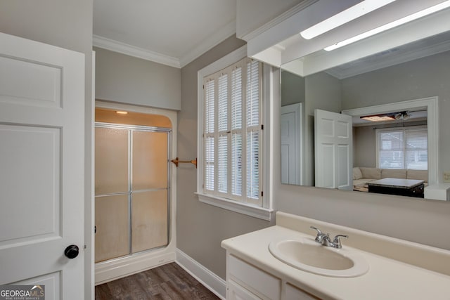 bathroom featuring vanity, crown molding, hardwood / wood-style flooring, and walk in shower