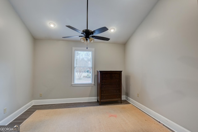 unfurnished room with ceiling fan and dark hardwood / wood-style flooring