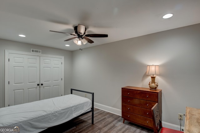 bedroom with wood-type flooring, ceiling fan, and a closet