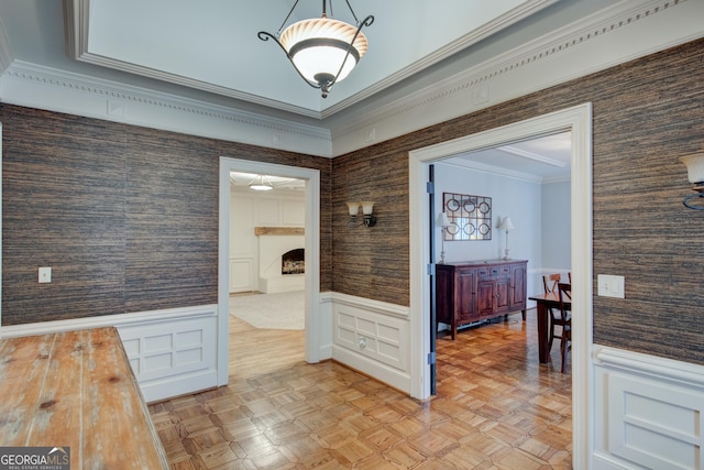 corridor featuring ornamental molding and light parquet floors