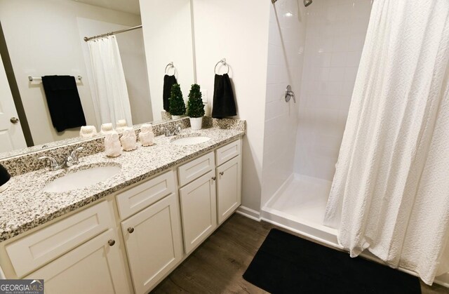 bathroom featuring hardwood / wood-style flooring, vanity, and a shower with curtain