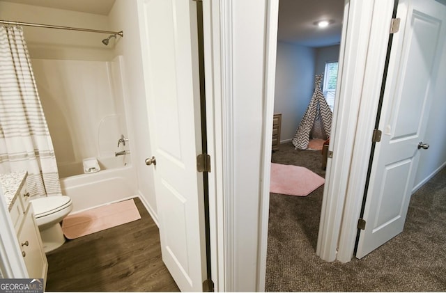 full bathroom featuring vanity, wood-type flooring, shower / bath combination with curtain, and toilet