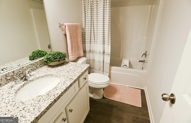 full bathroom featuring hardwood / wood-style flooring, shower / bath combo, vanity, and toilet