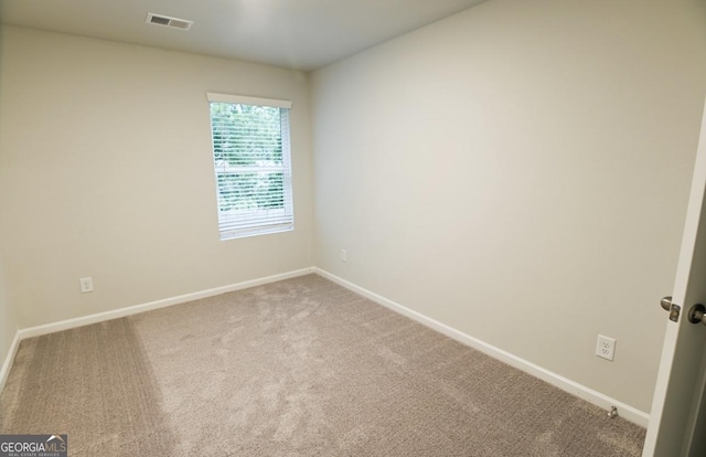 spare room featuring carpet flooring