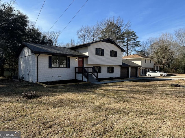 view of front of house with brick siding, a front lawn, and cooling unit