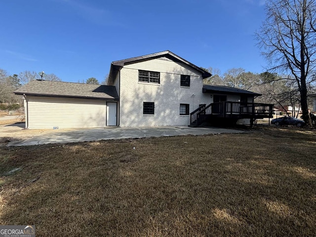 back of property featuring a yard, a patio area, brick siding, and a wooden deck