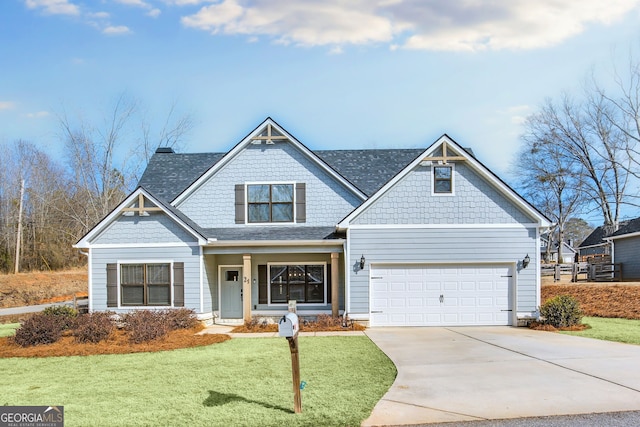 craftsman-style home featuring a garage and a front lawn