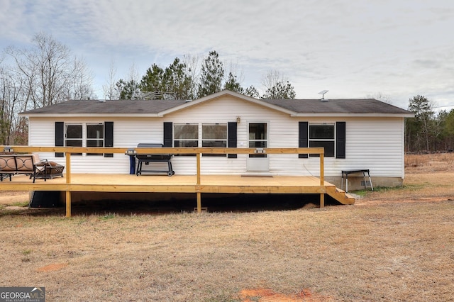 back of property featuring a wooden deck