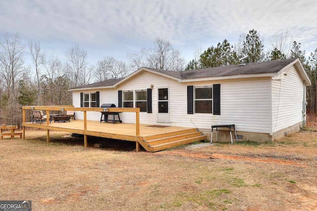 back of house featuring a deck