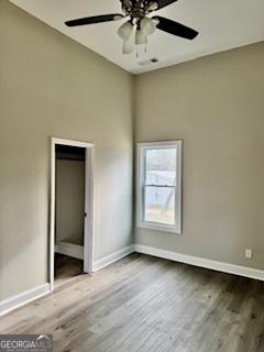 unfurnished bedroom with hardwood / wood-style floors and ceiling fan