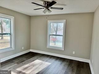 unfurnished room featuring ceiling fan and dark hardwood / wood-style flooring