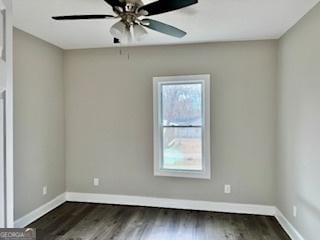 unfurnished room with ceiling fan and dark hardwood / wood-style flooring