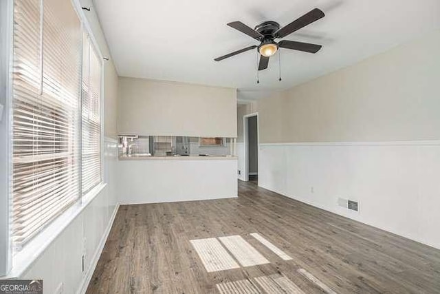 unfurnished living room featuring wood-type flooring and ceiling fan