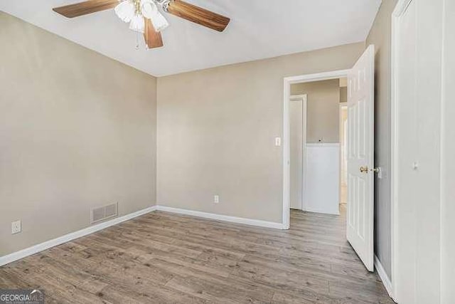 spare room with ceiling fan and light hardwood / wood-style flooring