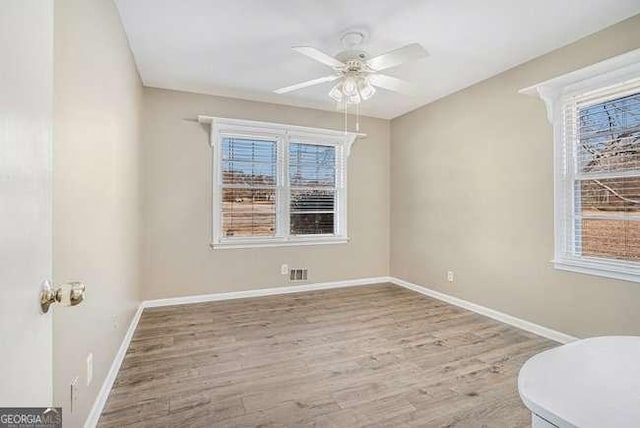 empty room with ceiling fan and light wood-type flooring