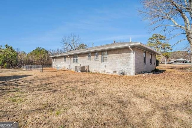 rear view of property featuring a yard