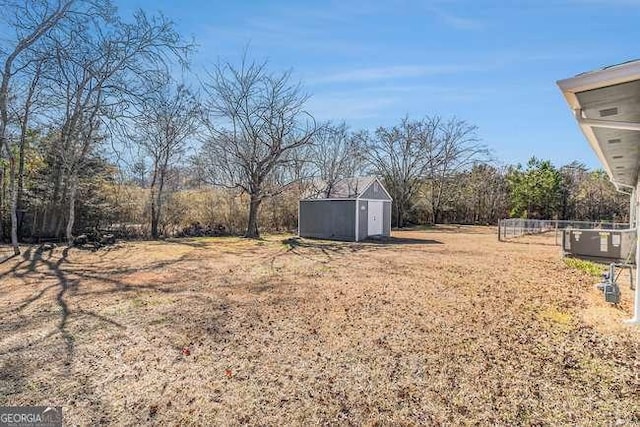 view of yard with central AC unit and a storage unit