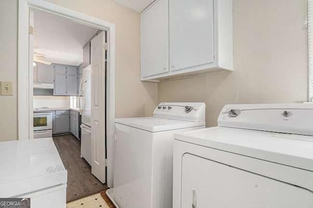 laundry room with washer and dryer and cabinets