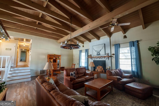 living room featuring lofted ceiling with beams, wood-type flooring, a wealth of natural light, and wood ceiling