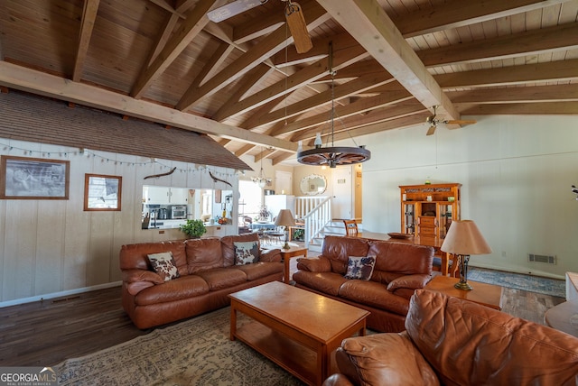 living room with ceiling fan with notable chandelier, wood walls, lofted ceiling with beams, hardwood / wood-style flooring, and wooden ceiling