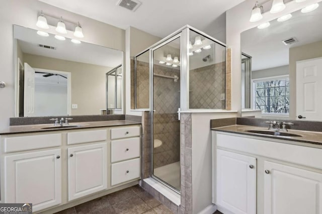 bathroom with vanity, an enclosed shower, and tile patterned flooring