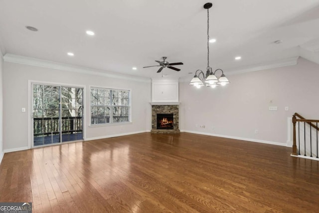 unfurnished living room with a fireplace, ceiling fan with notable chandelier, wood-type flooring, and ornamental molding