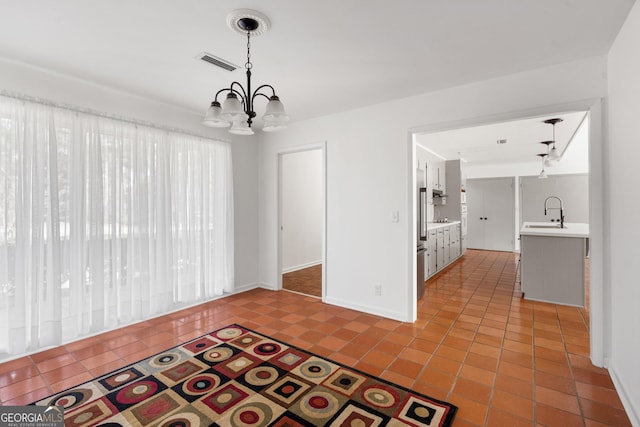 interior space featuring an inviting chandelier, sink, and light tile patterned floors