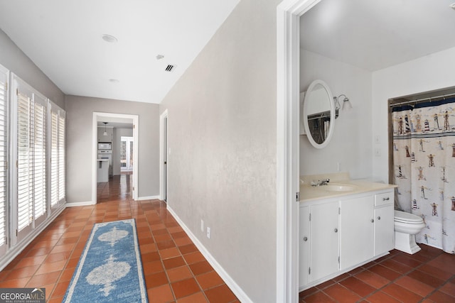 bathroom with vanity, tile patterned floors, and toilet