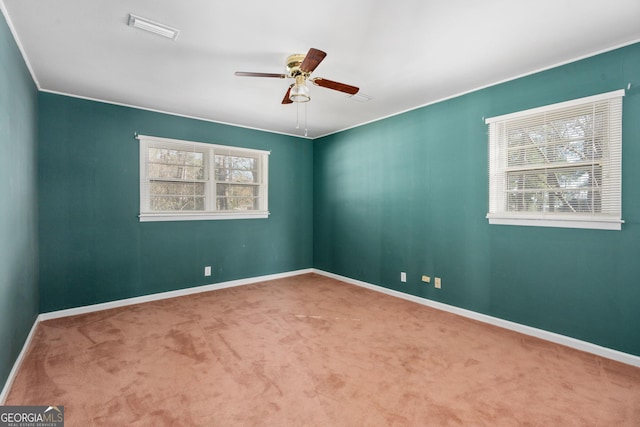 carpeted spare room with ceiling fan