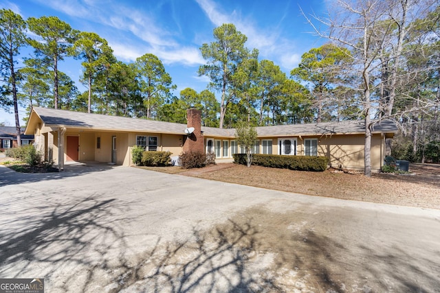 ranch-style home with a carport