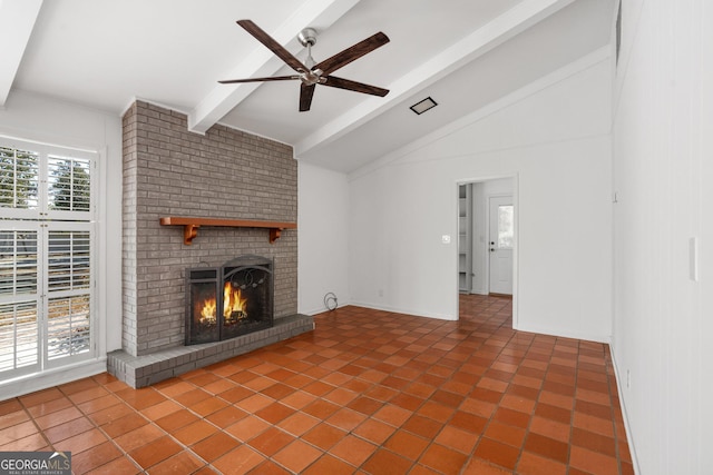 unfurnished living room with ceiling fan, tile patterned flooring, lofted ceiling with beams, and a brick fireplace