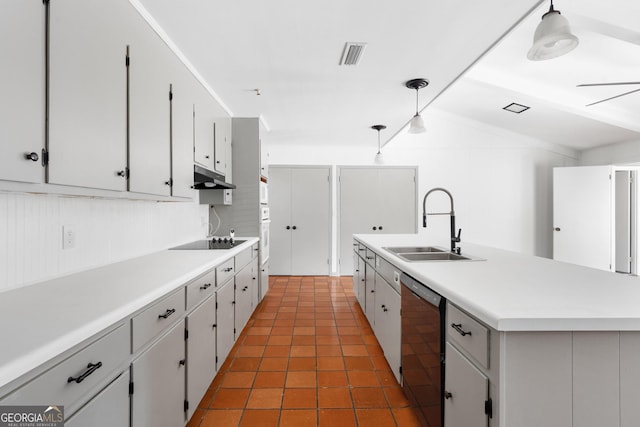 kitchen featuring black appliances, sink, a kitchen island with sink, and decorative light fixtures