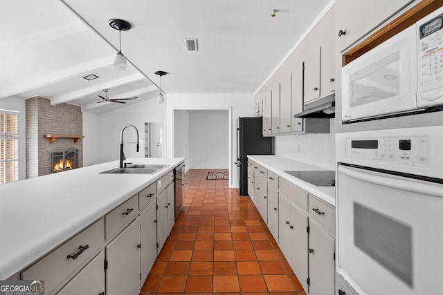 kitchen featuring sink, decorative light fixtures, black appliances, and white cabinets