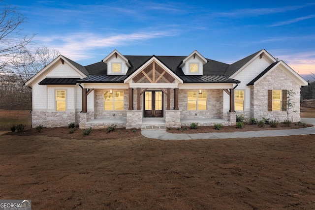 view of front of house with french doors and covered porch