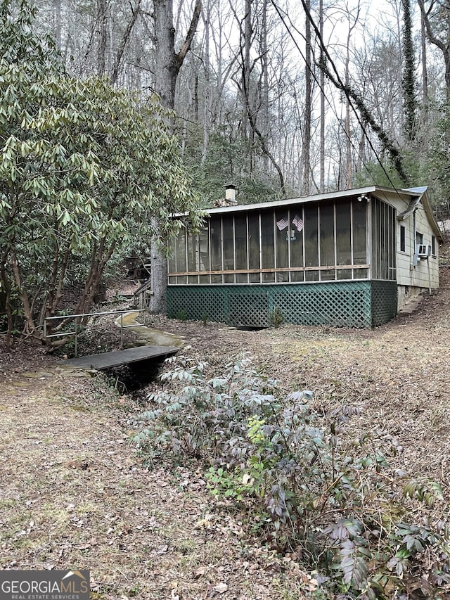 view of side of property with a sunroom