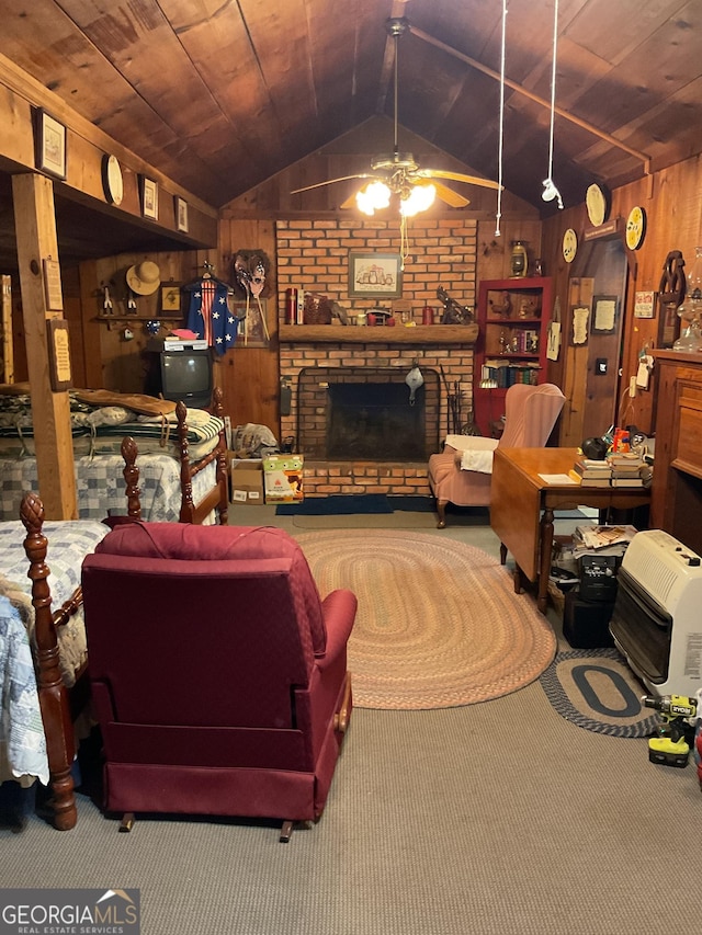 carpeted living room featuring lofted ceiling, wood ceiling, ceiling fan, a brick fireplace, and wood walls